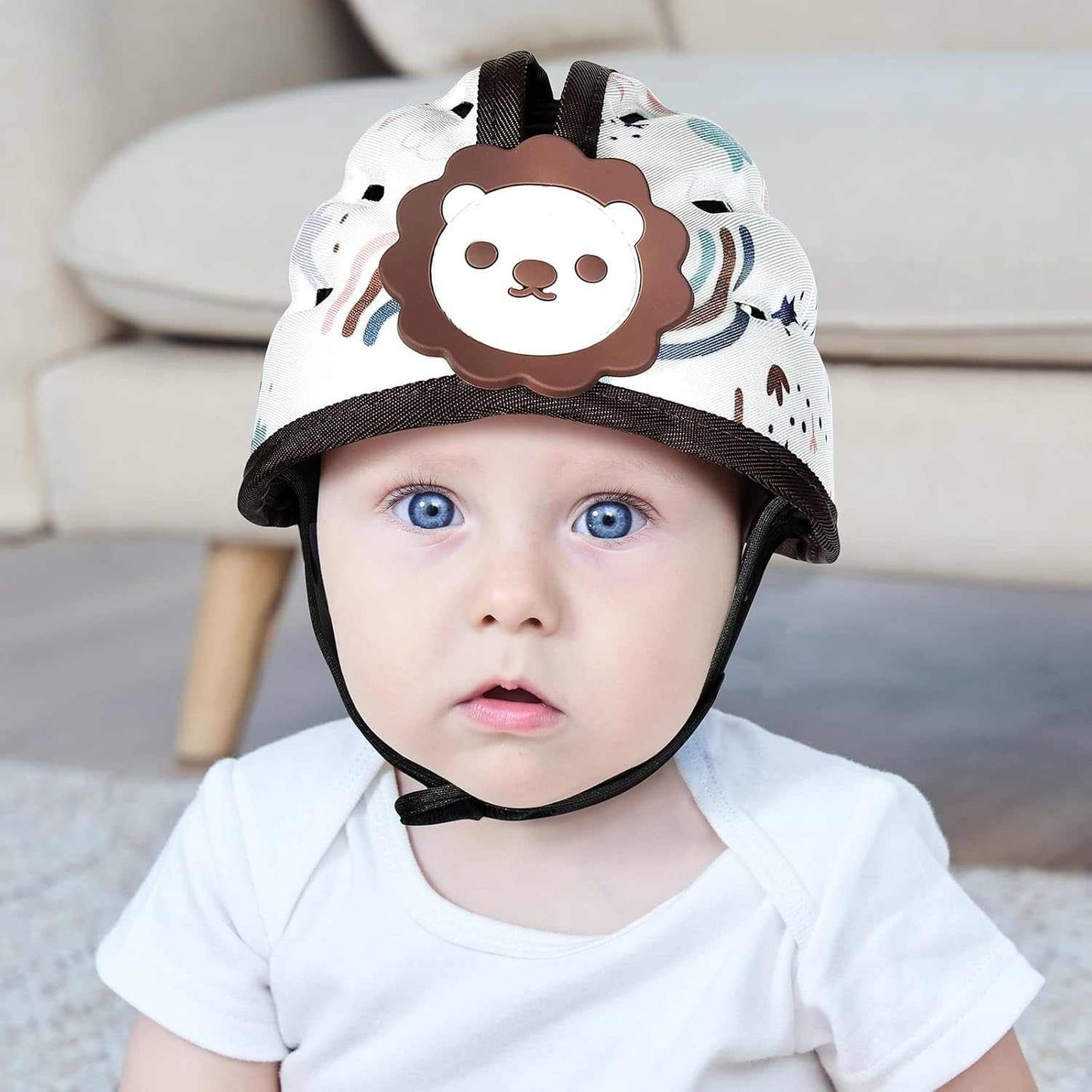 Baby wearing a helmet with a lion design in a home setting