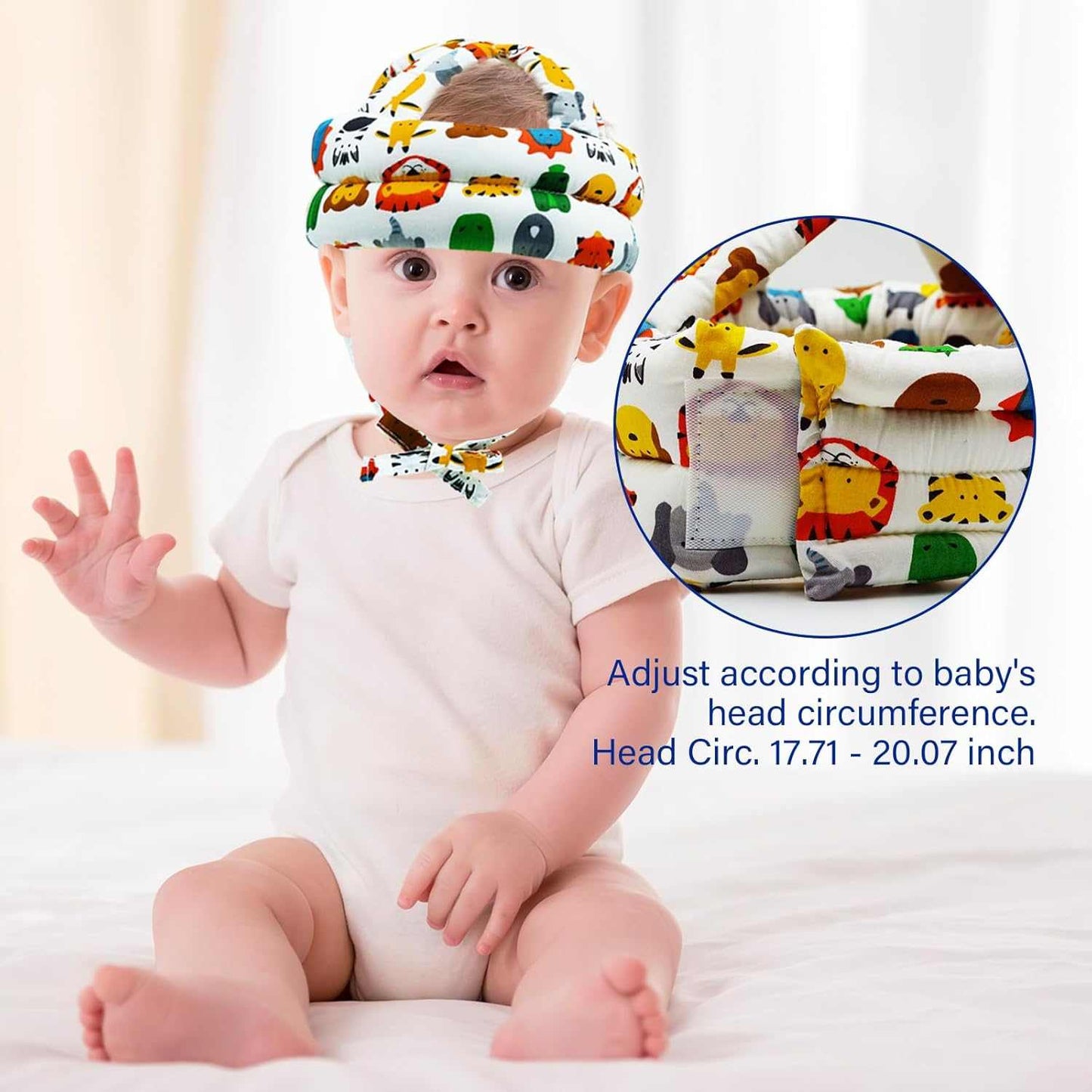 Baby wearing a colorful headband with cartoon designs, sitting on a white surface.