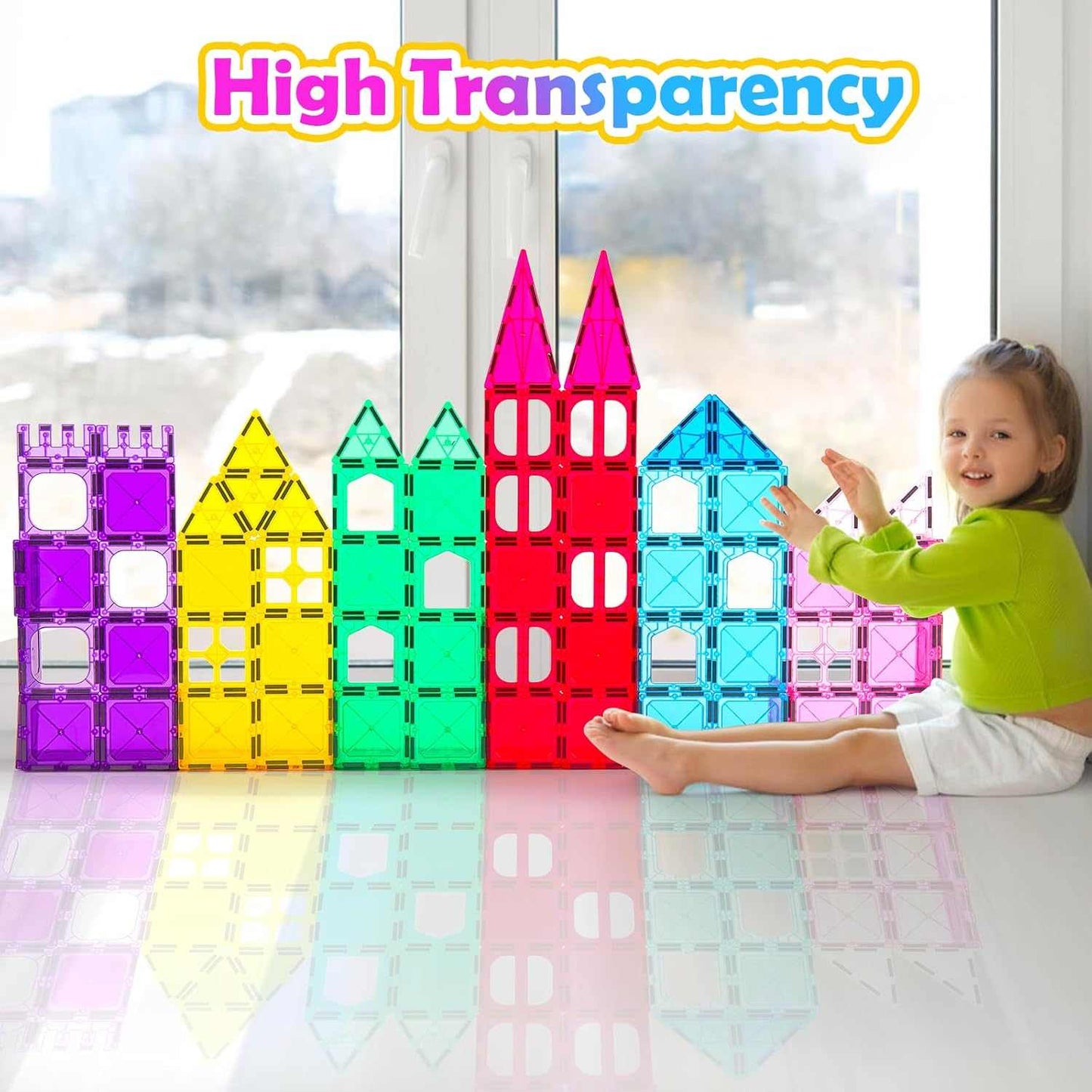 Magnetic Tiles 100PCS Colorful transparent building block toys on a table with a child interacting with them, labeled 'High Transparency'.