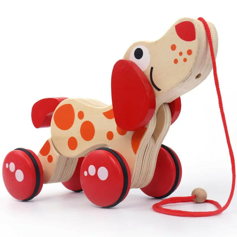 Wooden toy dog with red and orange spots on a white background