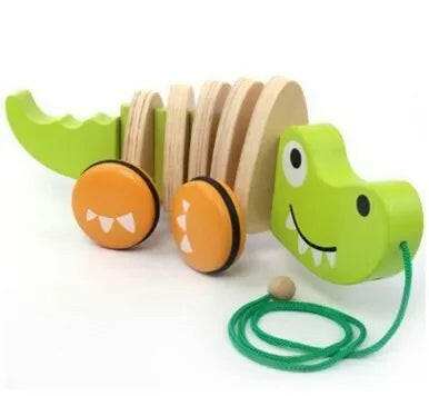 Green crocodile Pepê Wooden Animal Pull Toy with orange wheels and tow rope for toddlers.
