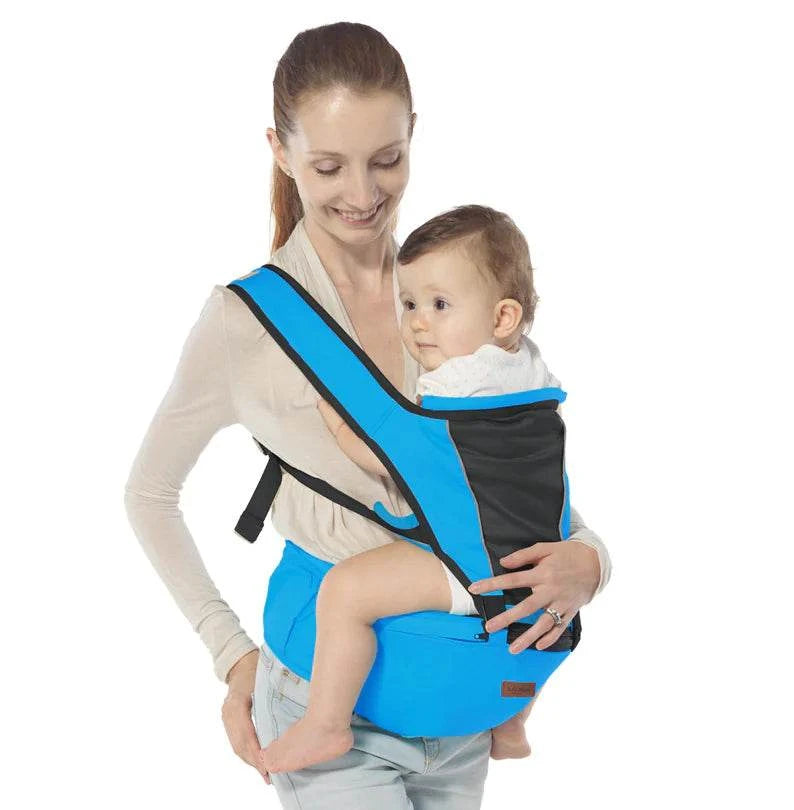 Woman holding a baby in a blue and black baby carrier against a white background