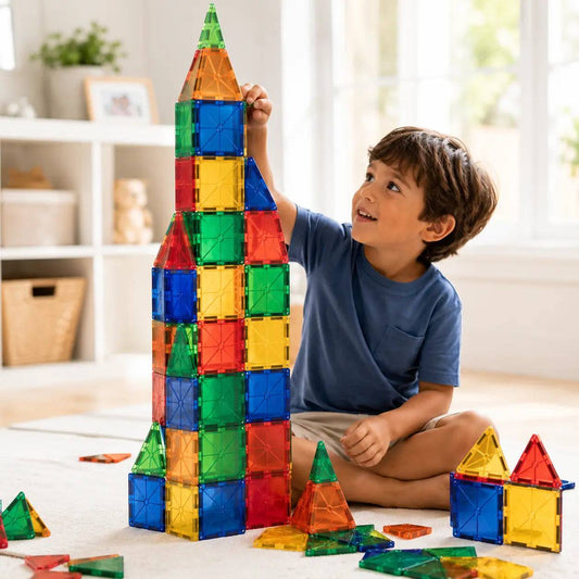 Child playing with colorful magnetic tiles STEM educational construction set