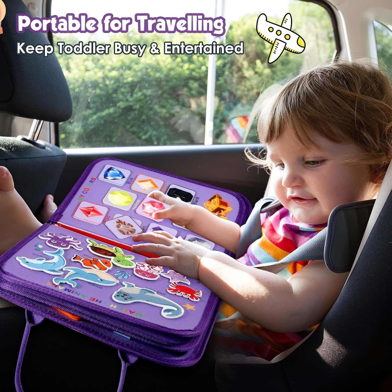 Child playing with a portable educational toy in a car