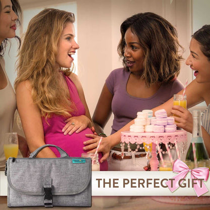 Pregnant woman with a gray bag at a baby shower with other women.