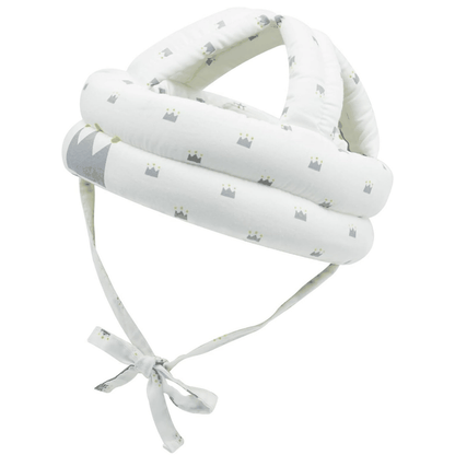 Baby wearing playful patterned baby safety helmet for lightweight head protection during crawling and walking stages
