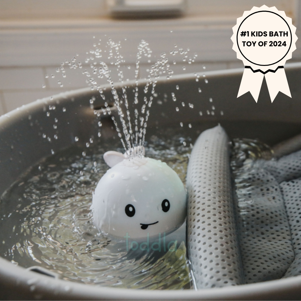 White bath toy with water sprayer in a bathtub, labeled as #1 Kids Bath Toy of 2025.