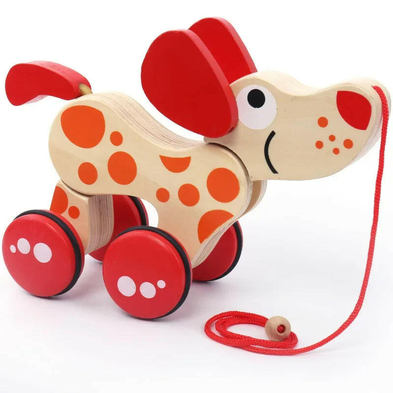 Wooden toy dog with red wheels and a pull string on a white background