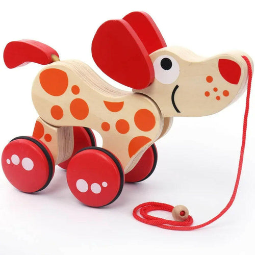Wooden toy dog with red wheels and a pull string on a white background