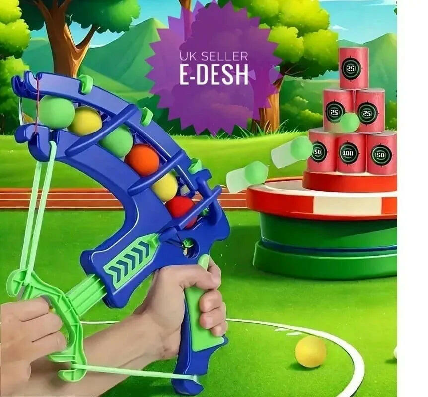 Toy slingshot with colorful balls in a playful outdoor setting, featuring E-Desh branding.