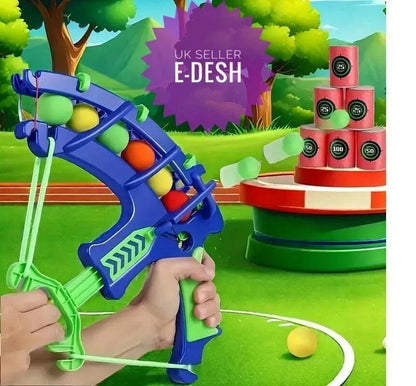 Toy slingshot with colorful balls in a playful outdoor setting, featuring E-Desh branding.