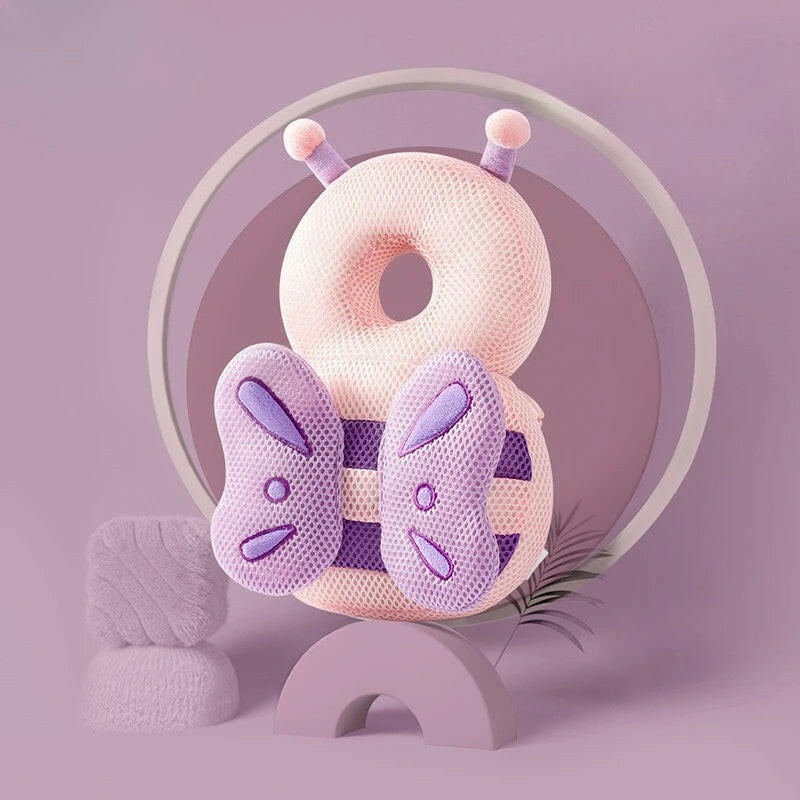 Pink and purple butterfly-shaped pillow with a circular design on a light purple background