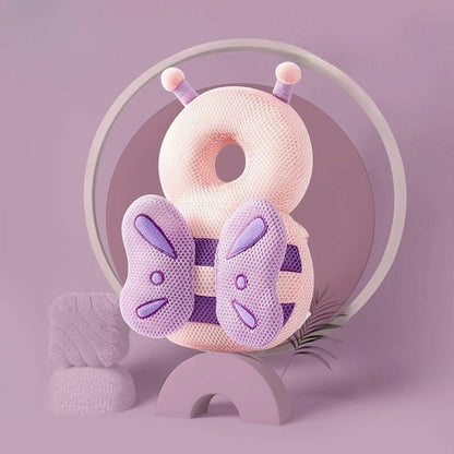 Pink and purple butterfly-shaped pillow with a circular design on a light purple background