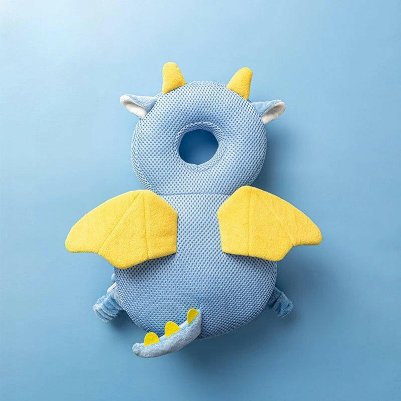 Blue dragon-shaped pillow with yellow accents on a light blue background