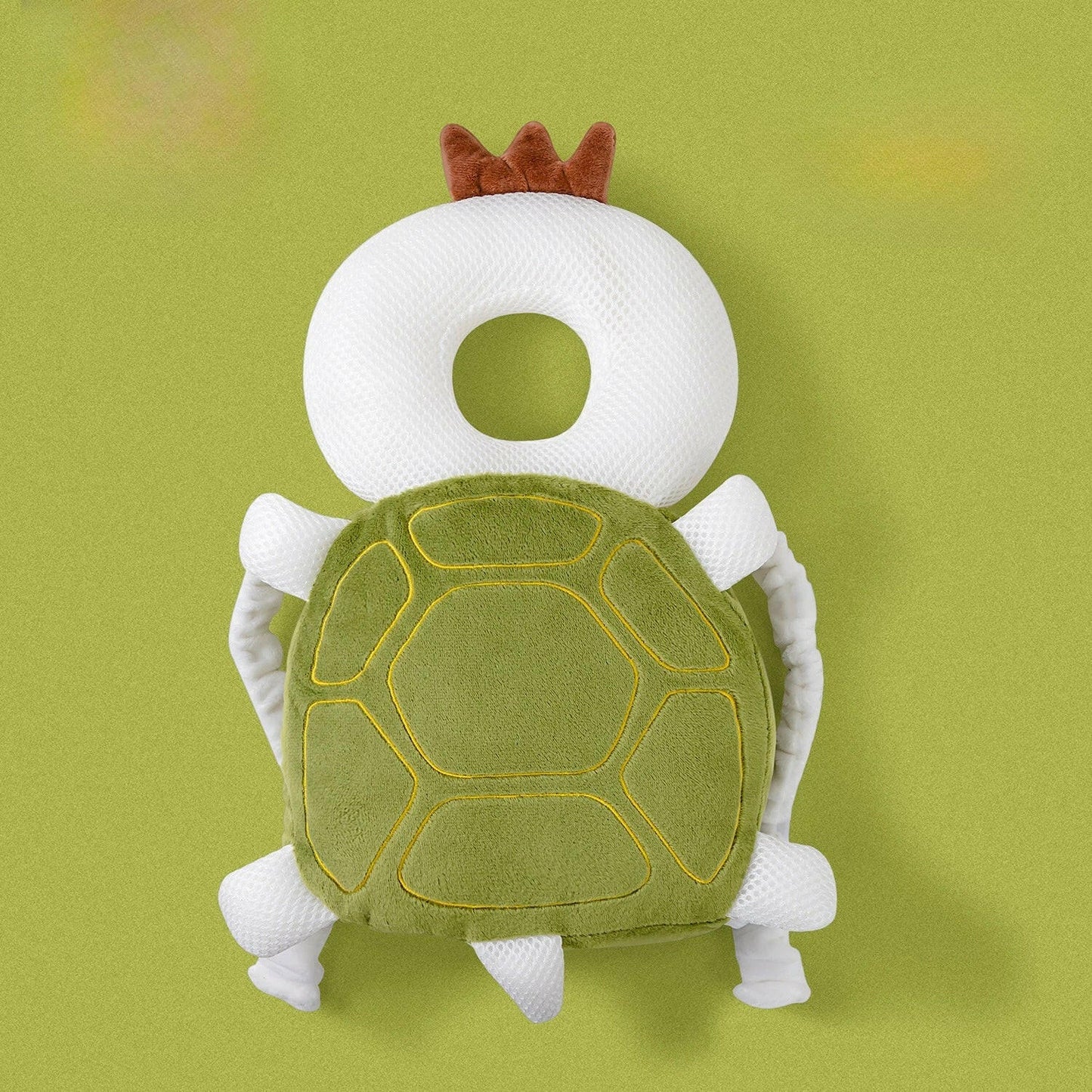 Plush turtle toy with a white ring on a green background