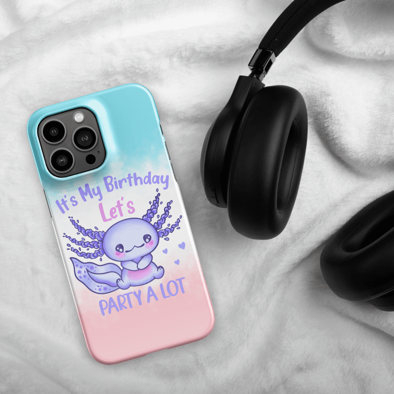 Phone case with a cute design and text, placed on a soft surface with headphones.